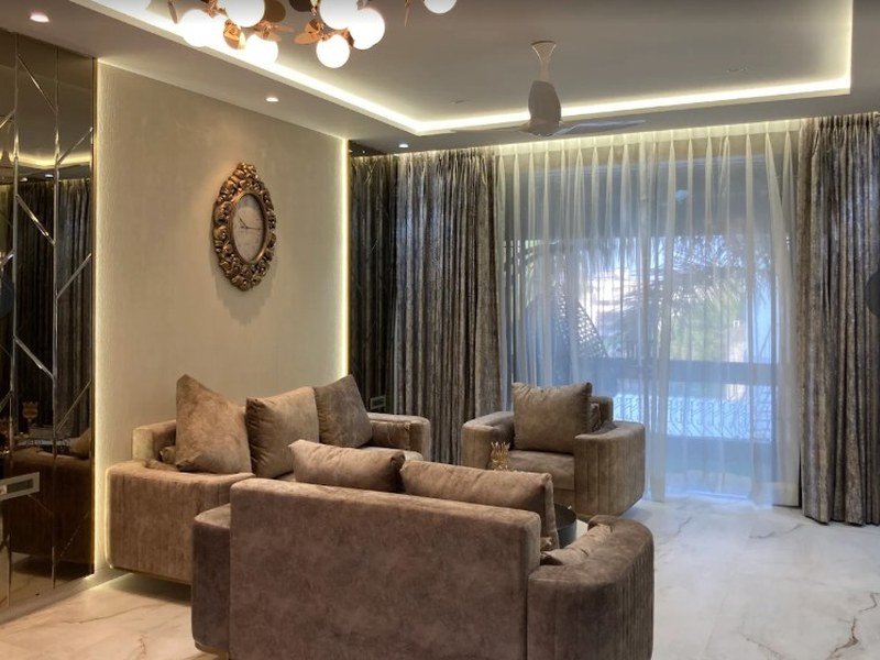 Living room styled by Eunoia Decor with layered drapery and warm lighting